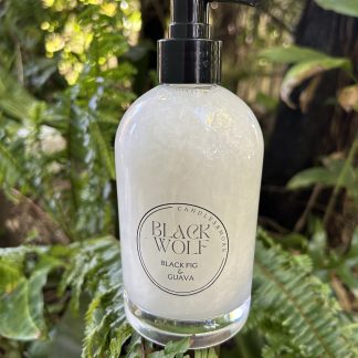 GOATS MILK SOAP IN A GLASS pump bottle with black pump in a tropical garden